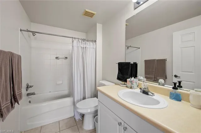 a bathroom with a sink toilet tub vanity and shower