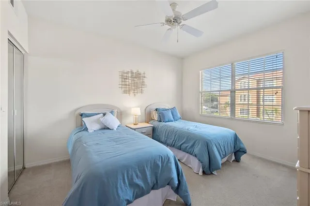 a bedroom with two beds and a window