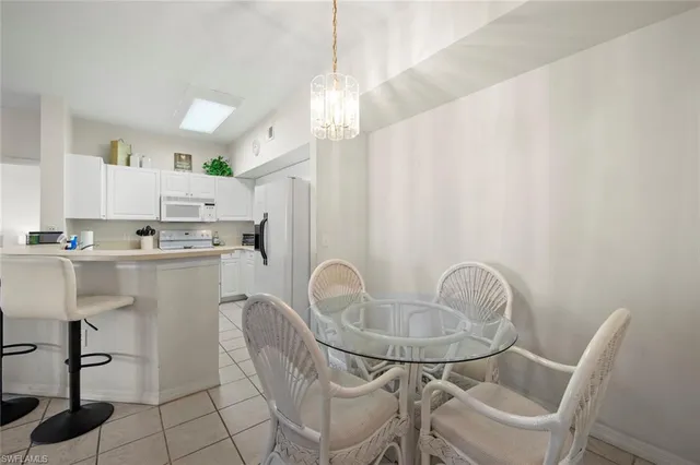 a kitchen with kitchen island a table and chairs