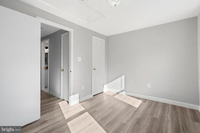 a view of empty room with wooden floor