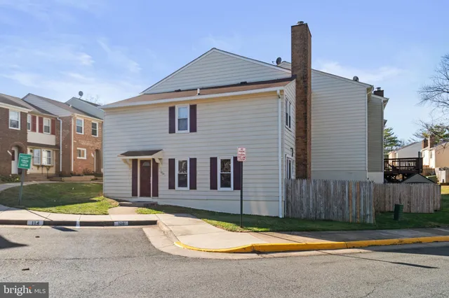 a view of a house with swimming pool and wooden fence