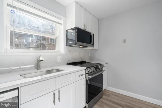 a kitchen with a stove and a sink