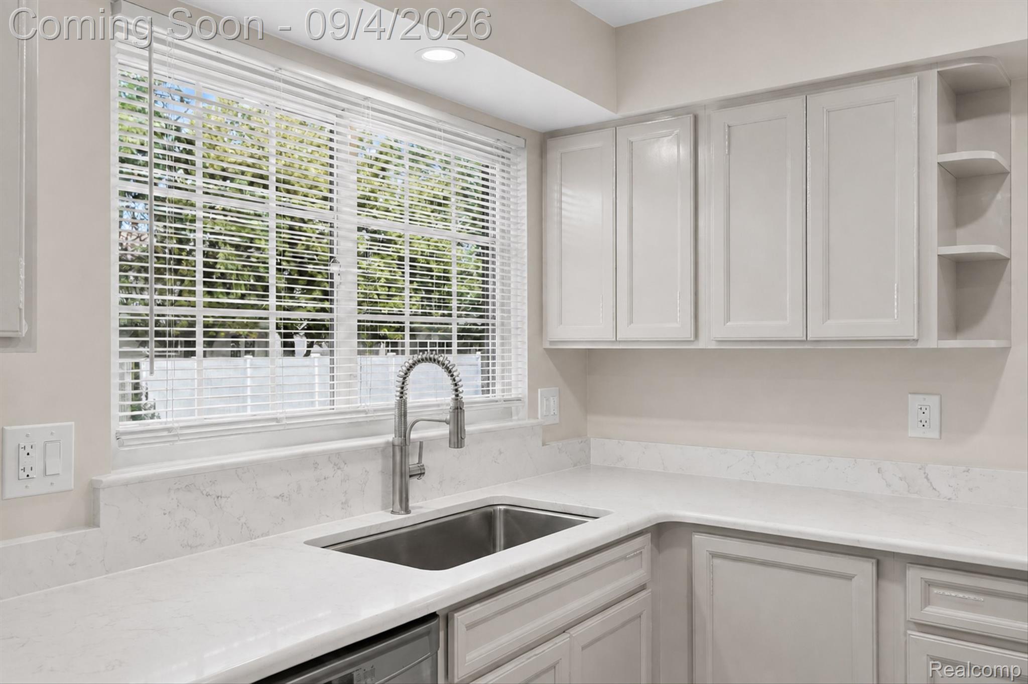 43182 Applewood Road Canton, MI 48188 - Photo 8 of 36 Stainless steel sink with a gooseneck faucet, light-toned countertops, white shaker-style cabinetry, and integrated shelving