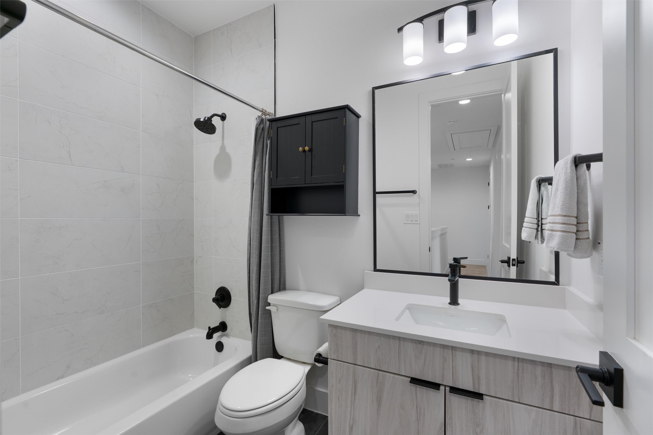 590 Old Mill Road, Unit 153 Cedar Park, TX 78613 - Photo 19 of 40 a bathroom with a sink a toilet a mirror and shower