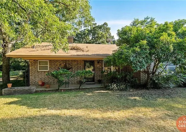 a view of a house with garden and sitting area