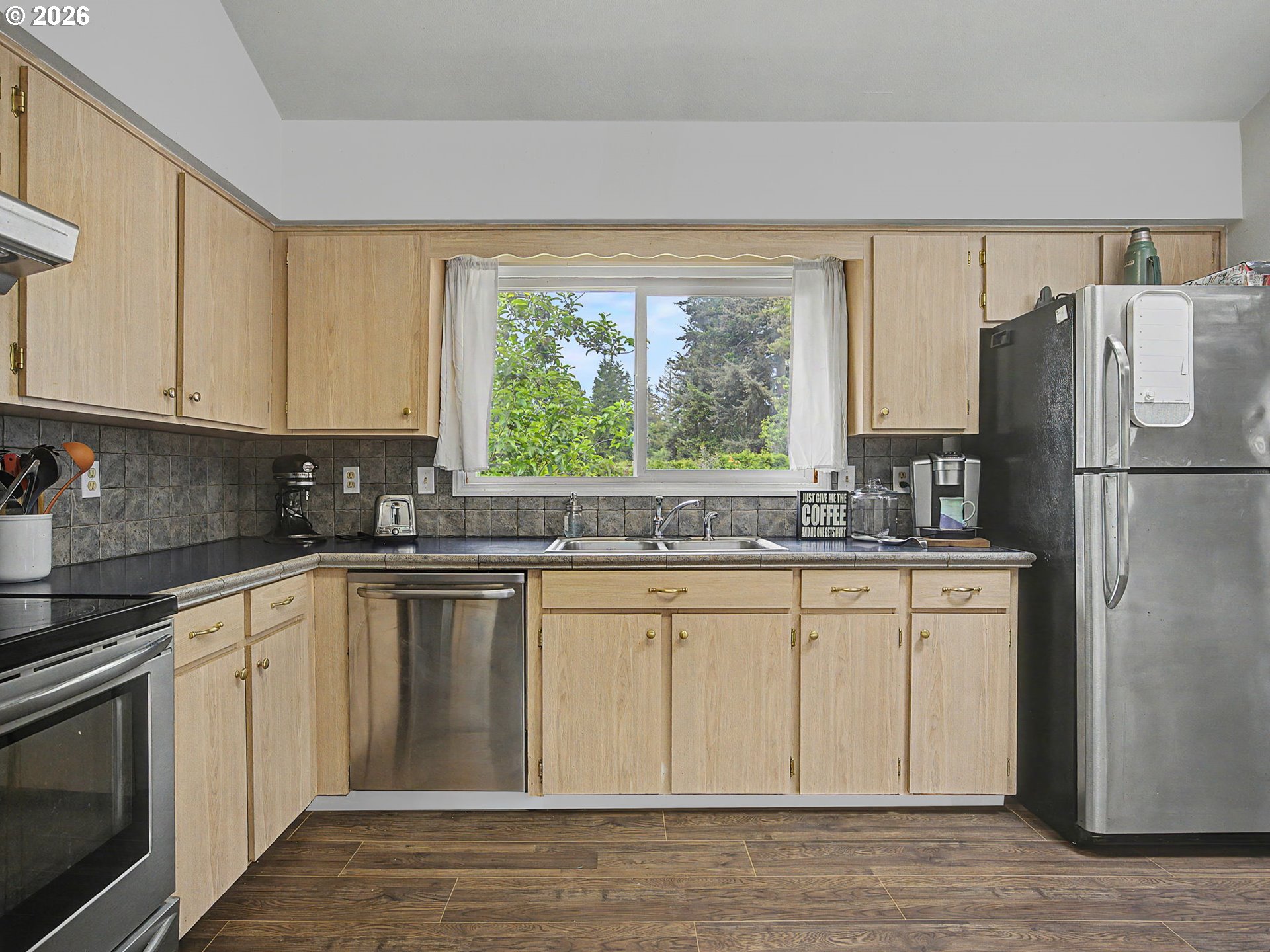 18015 Davis Street Sandy, OR 97055 - Photo 15 of 40 a kitchen with granite countertop a refrigerator sink and microwave