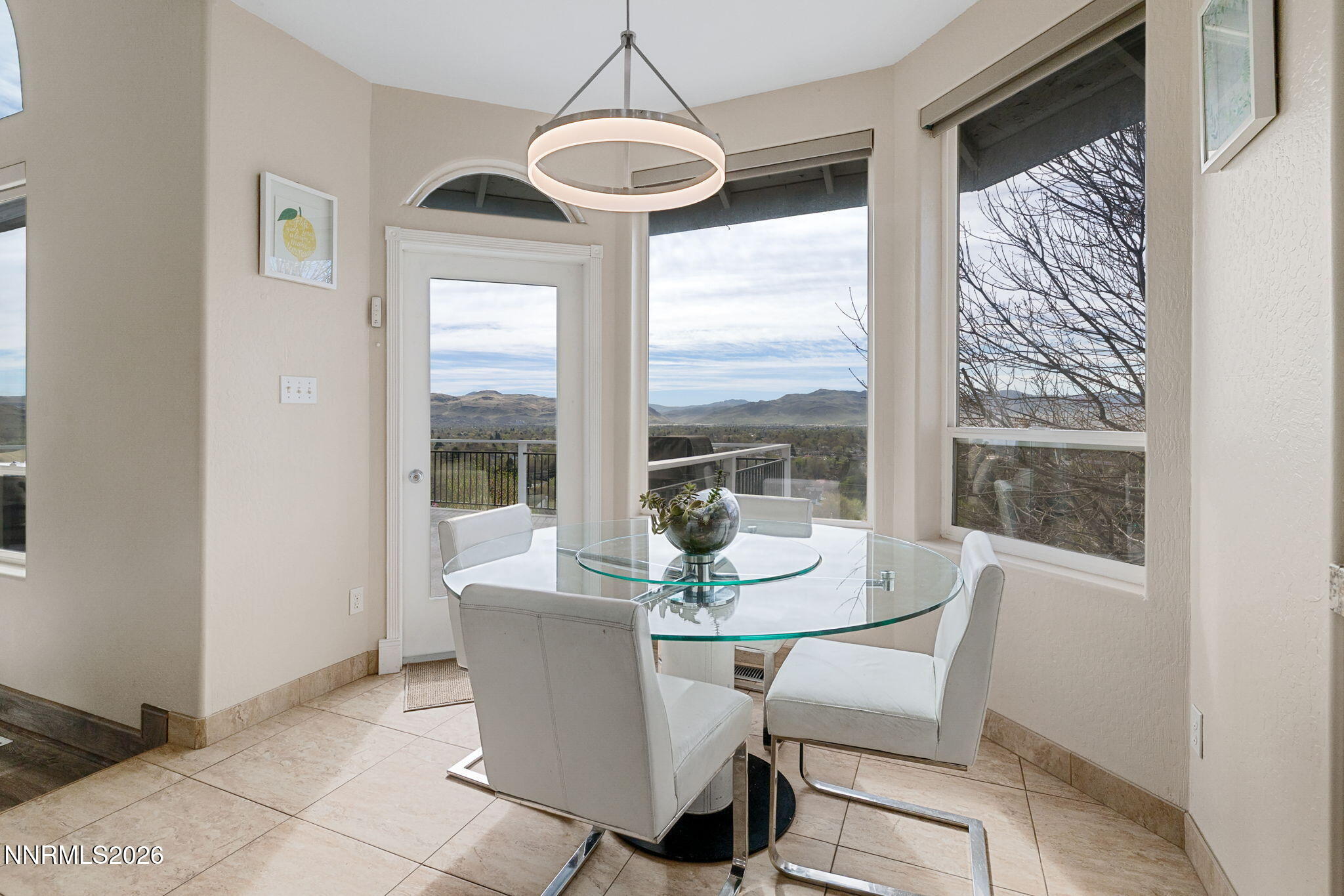 5520 High Rock Way Sparks, NV 89431 - Photo 20 of 75 a dining room with furniture large windows and a chandelier