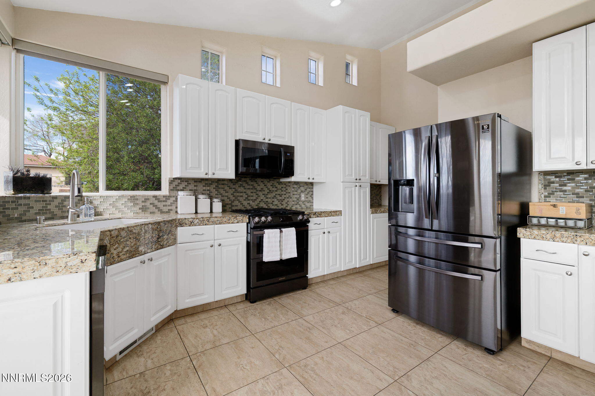 5520 High Rock Way Sparks, NV 89431 - Photo 21 of 75 a kitchen with granite countertop a refrigerator stove top oven and sink