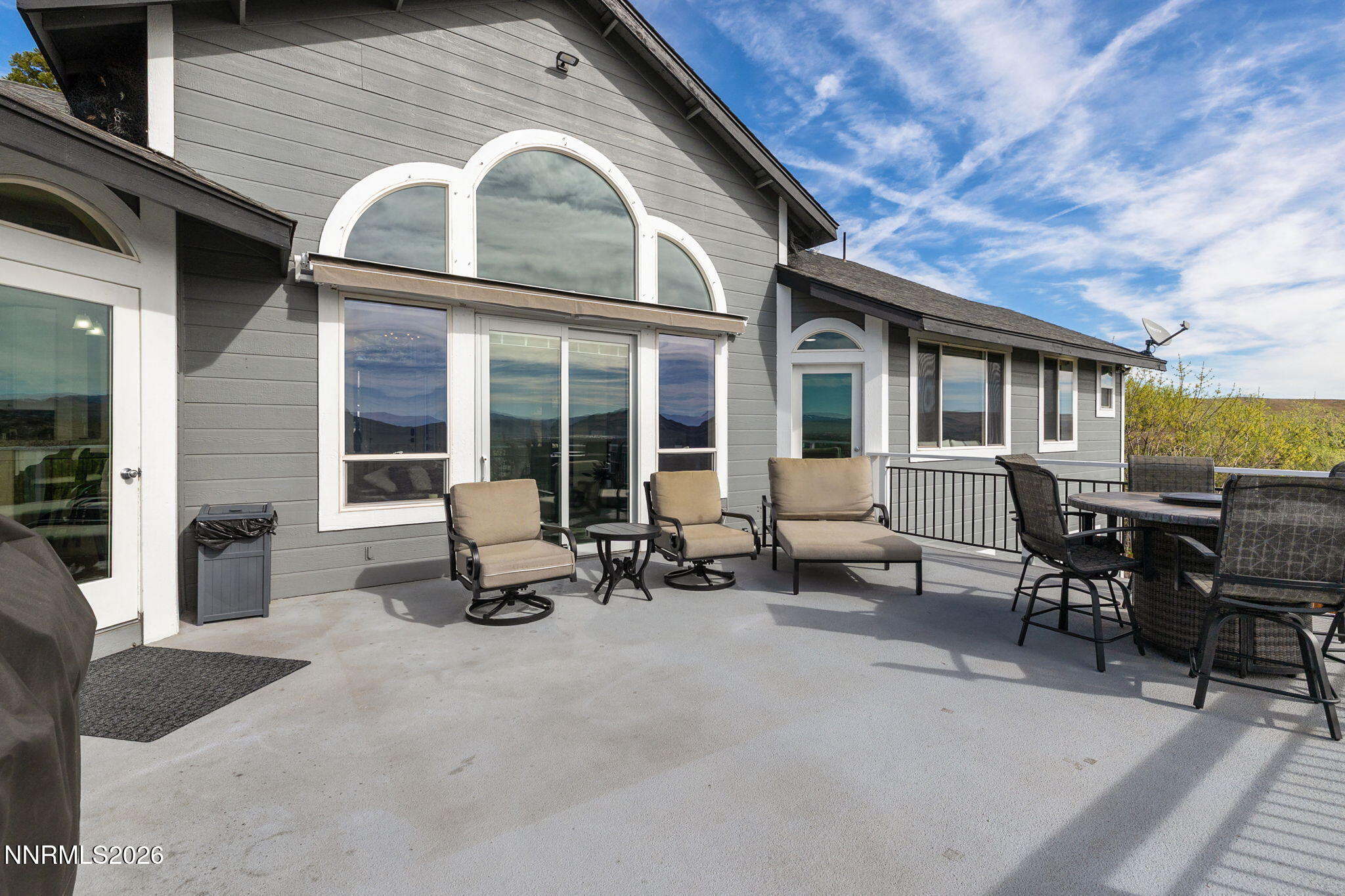 5520 High Rock Way Sparks, NV 89431 - Photo 30 of 75 a view of a patio with table and chairs with wooden floor and fence