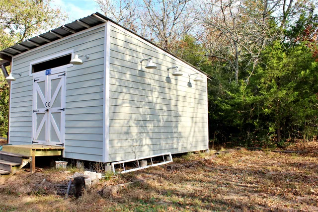 a backyard of a house with lots of trees