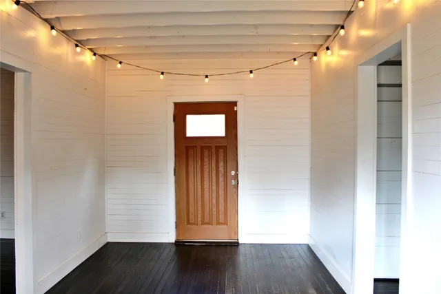a view of a hallway with wooden floor