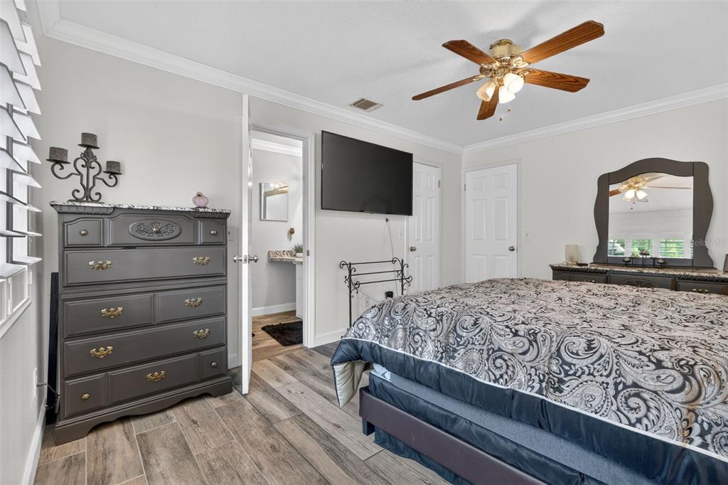 575 Tiberon Cove Road Longwood, FL 32750 - Photo 29 of 56 a bedroom with a bed and a flat screen tv