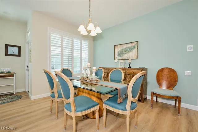 a view of a dining room with furniture and chandelier