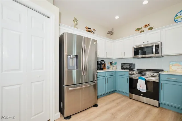 a kitchen with stainless steel appliances a refrigerator stove and microwave