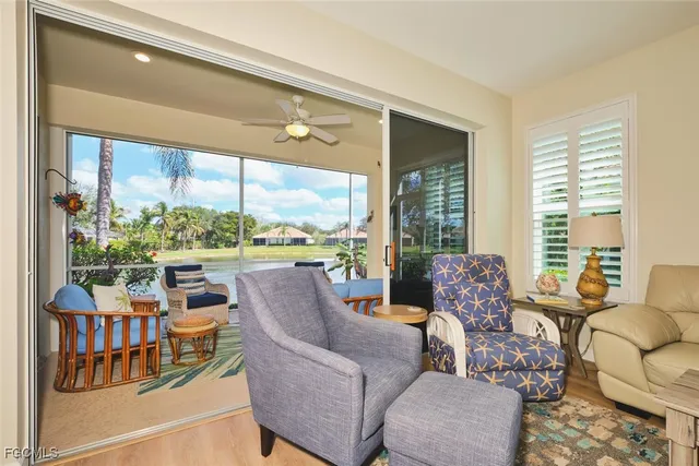 a living room with furniture and a floor to ceiling window