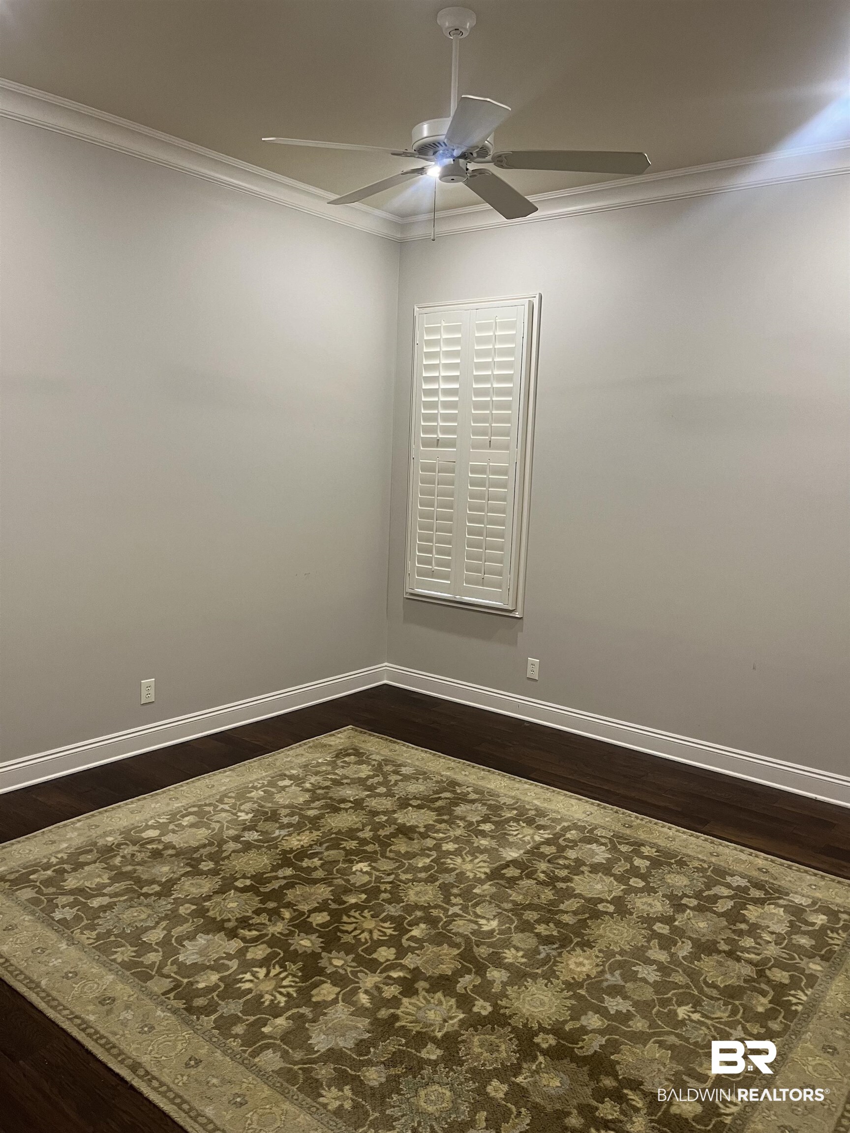 565 Falling Water Boulevard Fairhope, AL 36532 - Photo 19 of 27 Unfurnished room featuring ornamental molding, hardwood / wood-style flooring, and ceiling fan