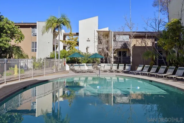 a view of a swimming pool with outdoor seating