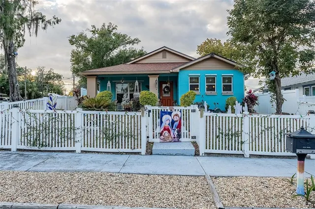 a front view of a house with a fence