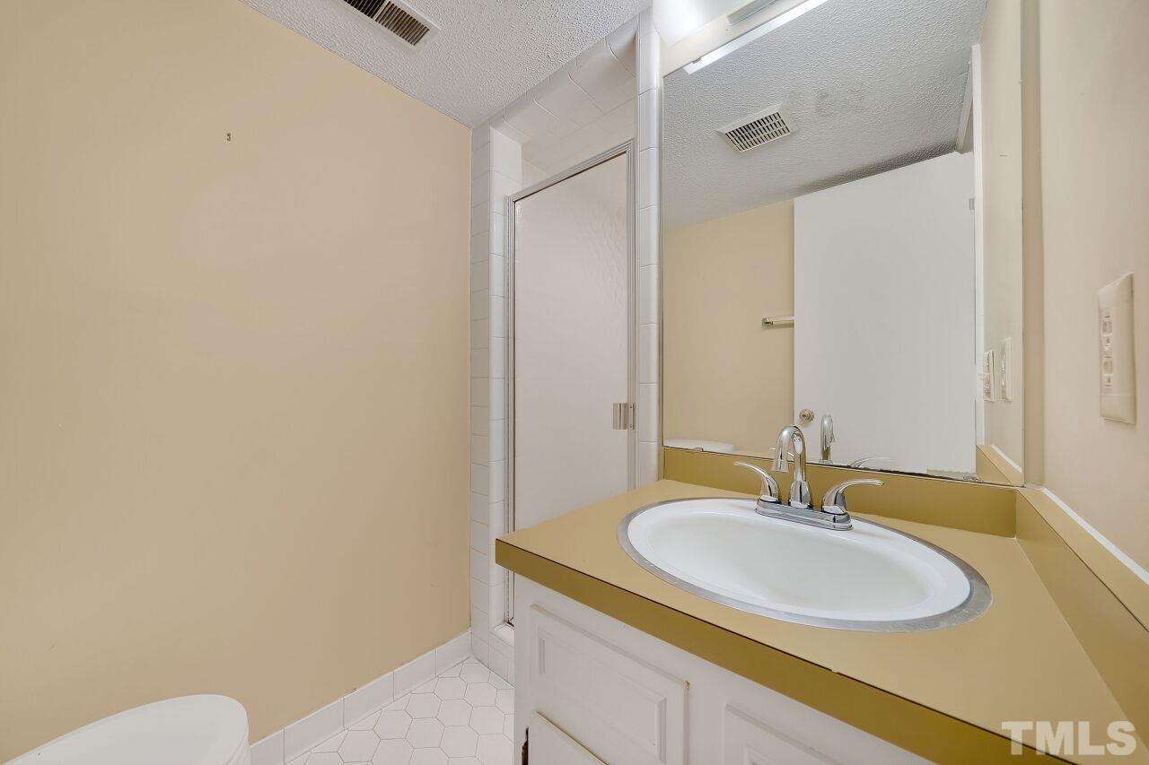 3413 Malibu Drive Raleigh, NC 27607 - Photo 13 of 30 a bathroom with a sink and a mirror