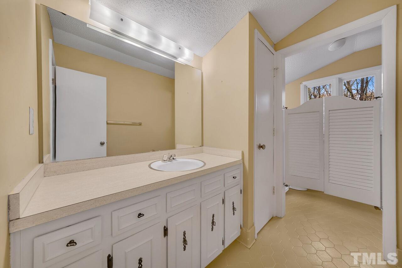 3413 Malibu Drive Raleigh, NC 27607 - Photo 16 of 30 a spacious bathroom with a sink and a mirror