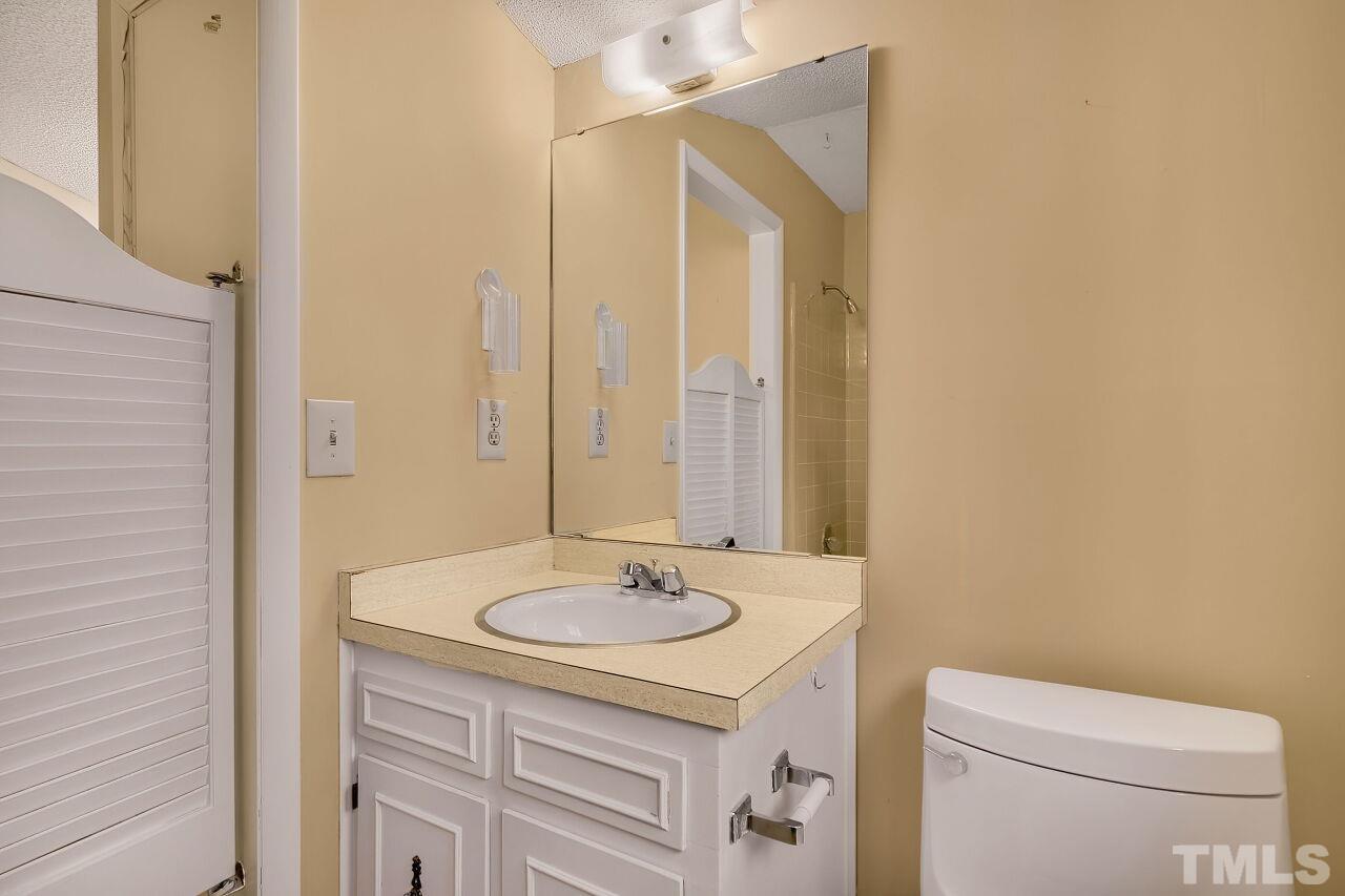 3413 Malibu Drive Raleigh, NC 27607 - Photo 17 of 30 a bathroom with a sink a toilet and shower