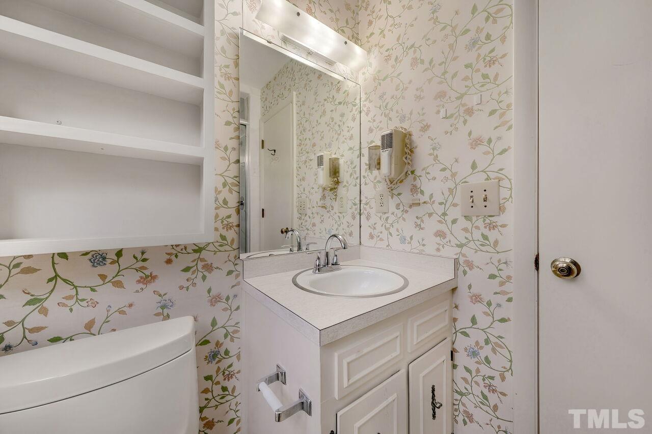 3413 Malibu Drive Raleigh, NC 27607 - Photo 21 of 30 a bathroom with a sink and a mirror