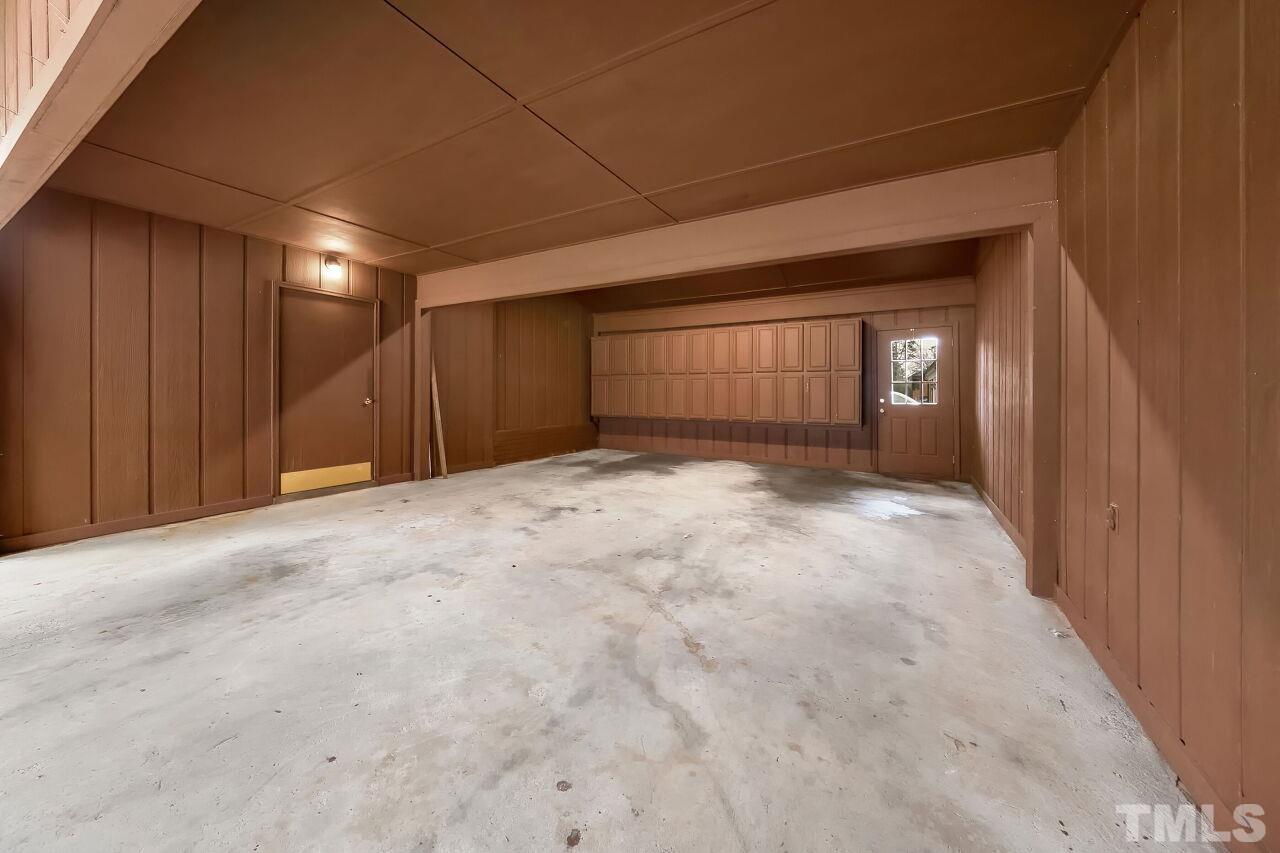 3413 Malibu Drive Raleigh, NC 27607 - Photo 26 of 30 a view of an empty room with wooden floor and a window