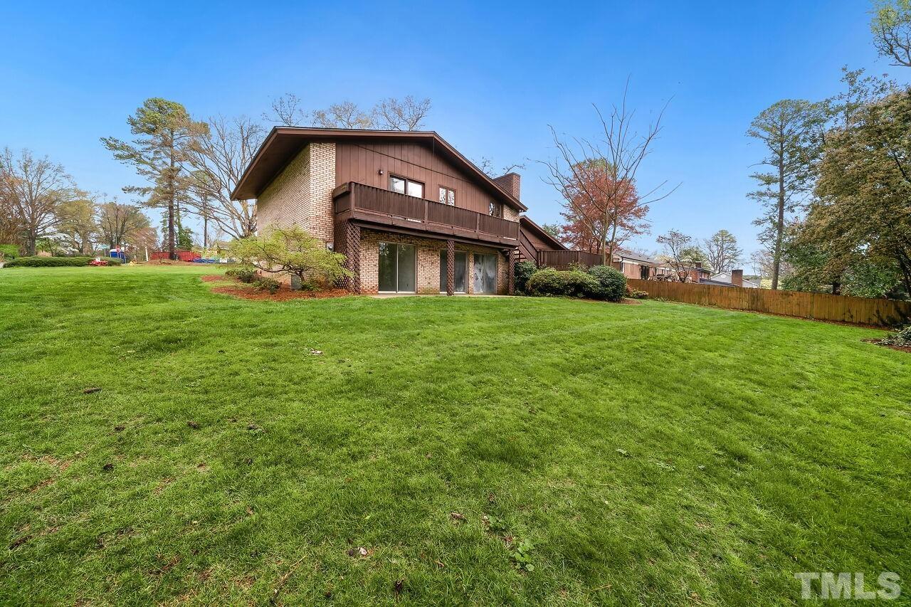 3413 Malibu Drive Raleigh, NC 27607 - Photo 28 of 30 a front view of a house with a garden