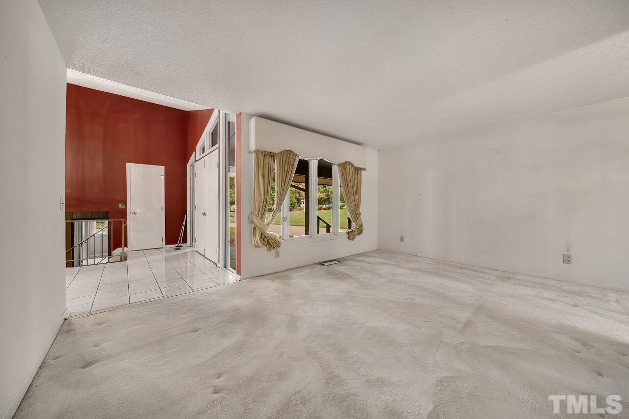 3413 Malibu Drive Raleigh, NC 27607 - Photo 5 of 30 a view of an empty room with a window
