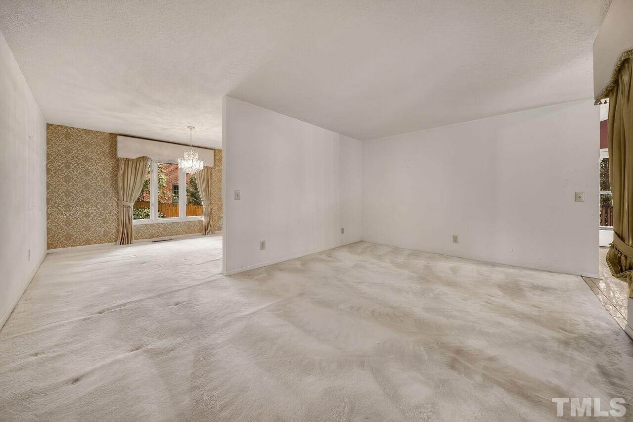 3413 Malibu Drive Raleigh, NC 27607 - Photo 6 of 30 a view of an empty room with a fireplace