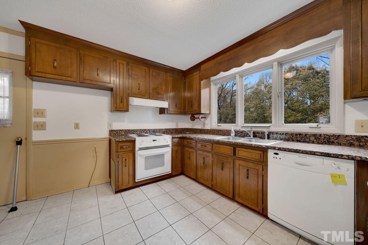 3413 Malibu Drive Raleigh, NC 27607 - Photo 10 of 30 a kitchen with a stove sink and cabinets