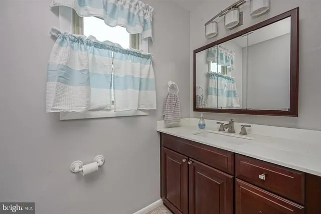 a bathroom with a sink vanity and mirror