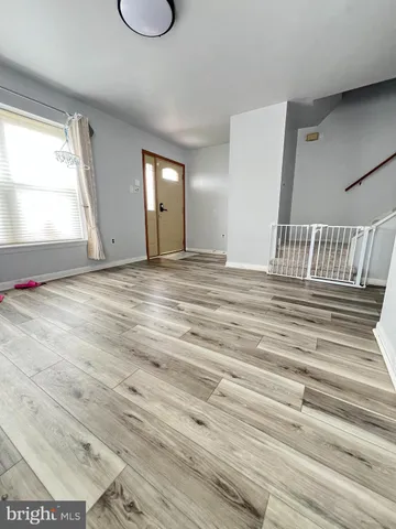 a view of a room with wooden floor and window