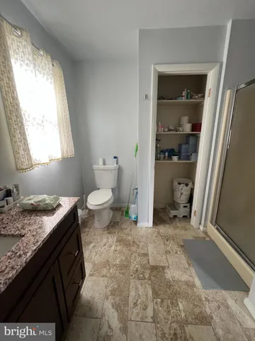 a bathroom with a granite countertop sink and a vanity