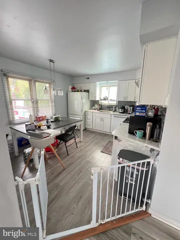 a living room with furniture a flat screen tv and a large window