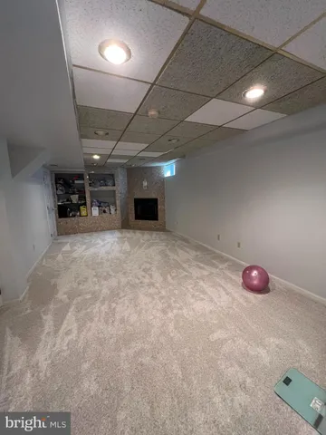 an empty room with projector and furniture