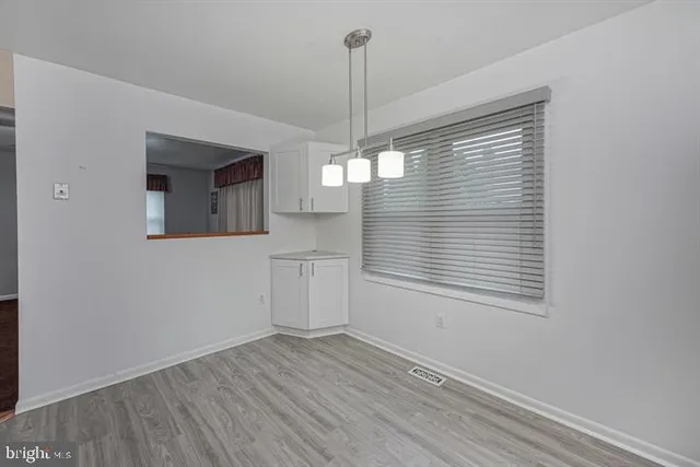 a view of a kitchen with a dishwasher cabinets and a window