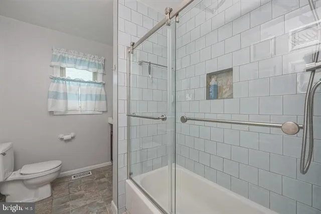 a bathroom with a toilet and shower