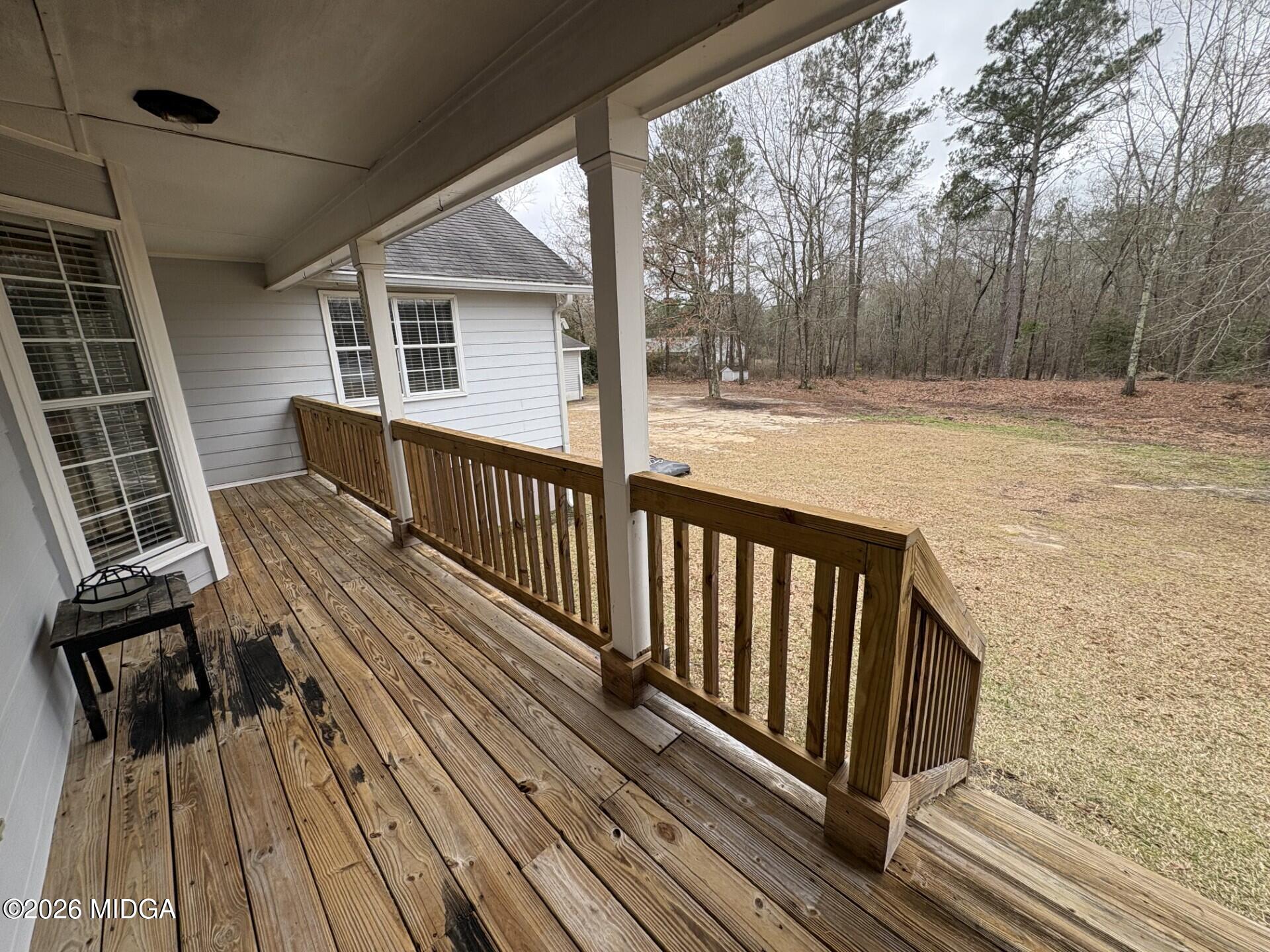 5081 Marshall Mill Road Lizella, GA 31052 - Photo 11 of 40 a view of backyard with wooden deck and large trees