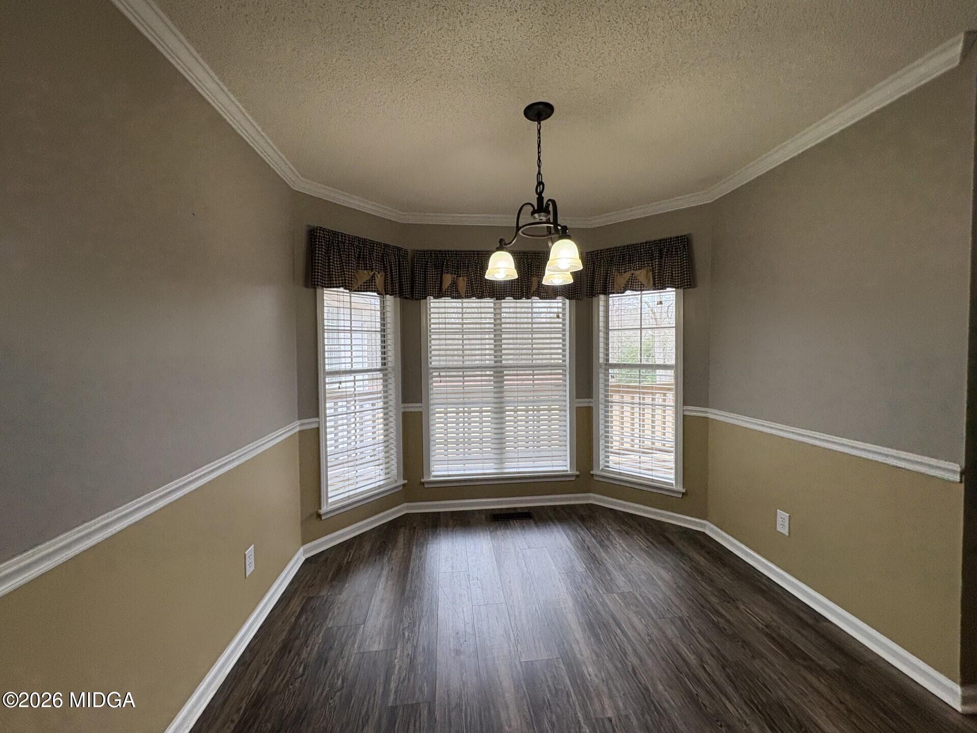 5081 Marshall Mill Road Lizella, GA 31052 - Photo 17 of 40 a view of empty room with wooden floor and fan
