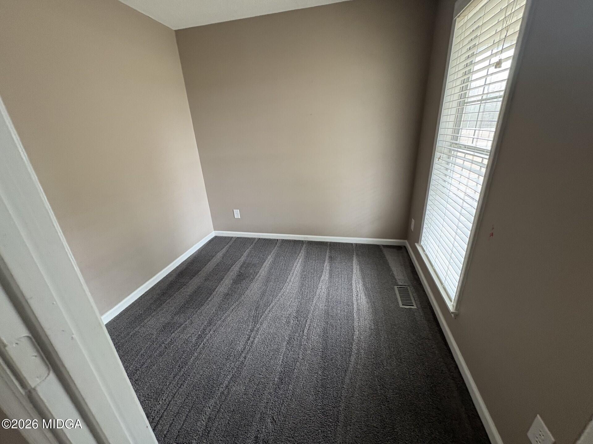 5081 Marshall Mill Road Lizella, GA 31052 - Photo 23 of 40 wooden floor in an empty room with a window