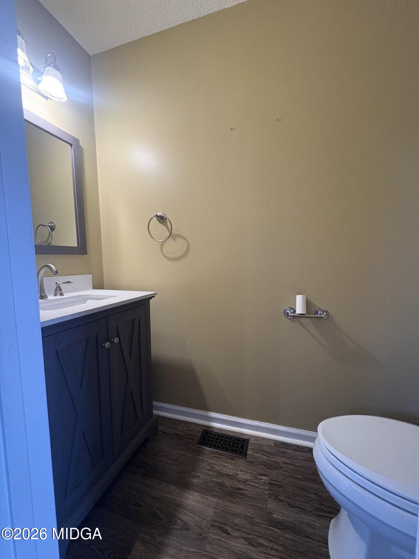 5081 Marshall Mill Road Lizella, GA 31052 - Photo 24 of 40 a bathroom with a granite countertop toilet and a sink