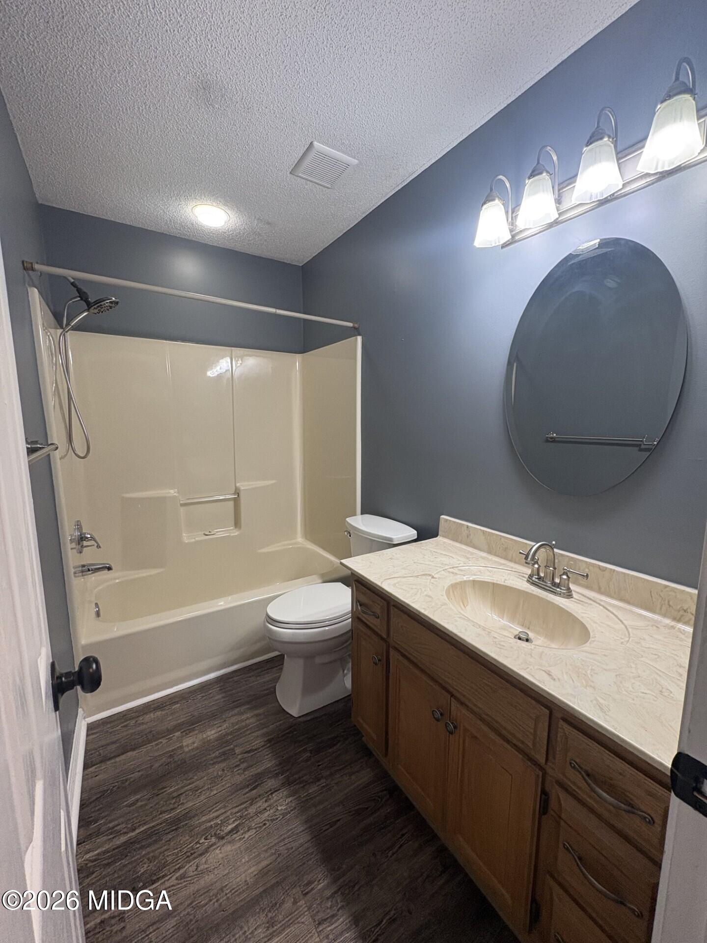 5081 Marshall Mill Road Lizella, GA 31052 - Photo 27 of 40 a bathroom with a sink a toilet and a mirror