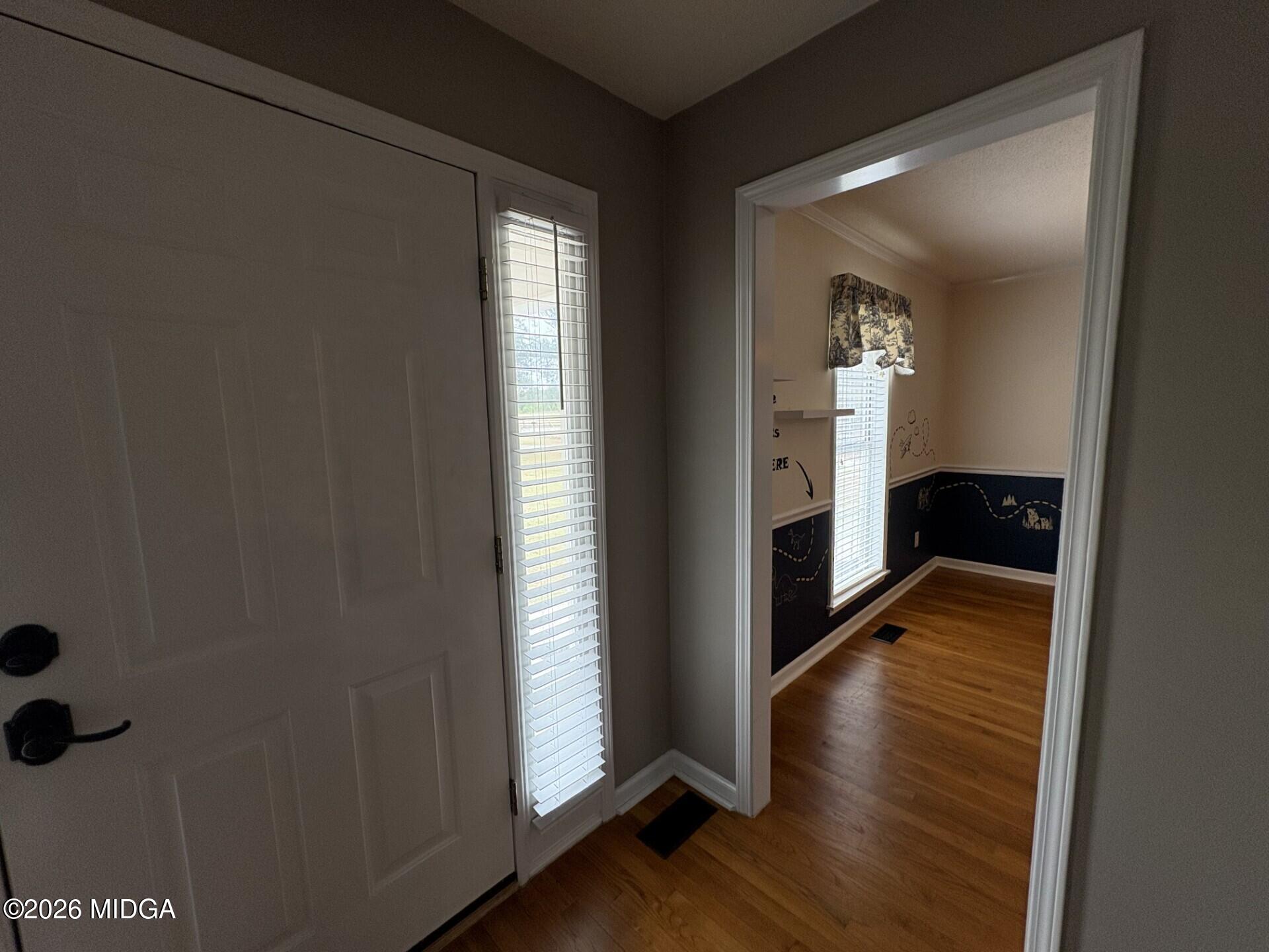 5081 Marshall Mill Road Lizella, GA 31052 - Photo 7 of 40 a view of hallway with wooden floor and fireplace