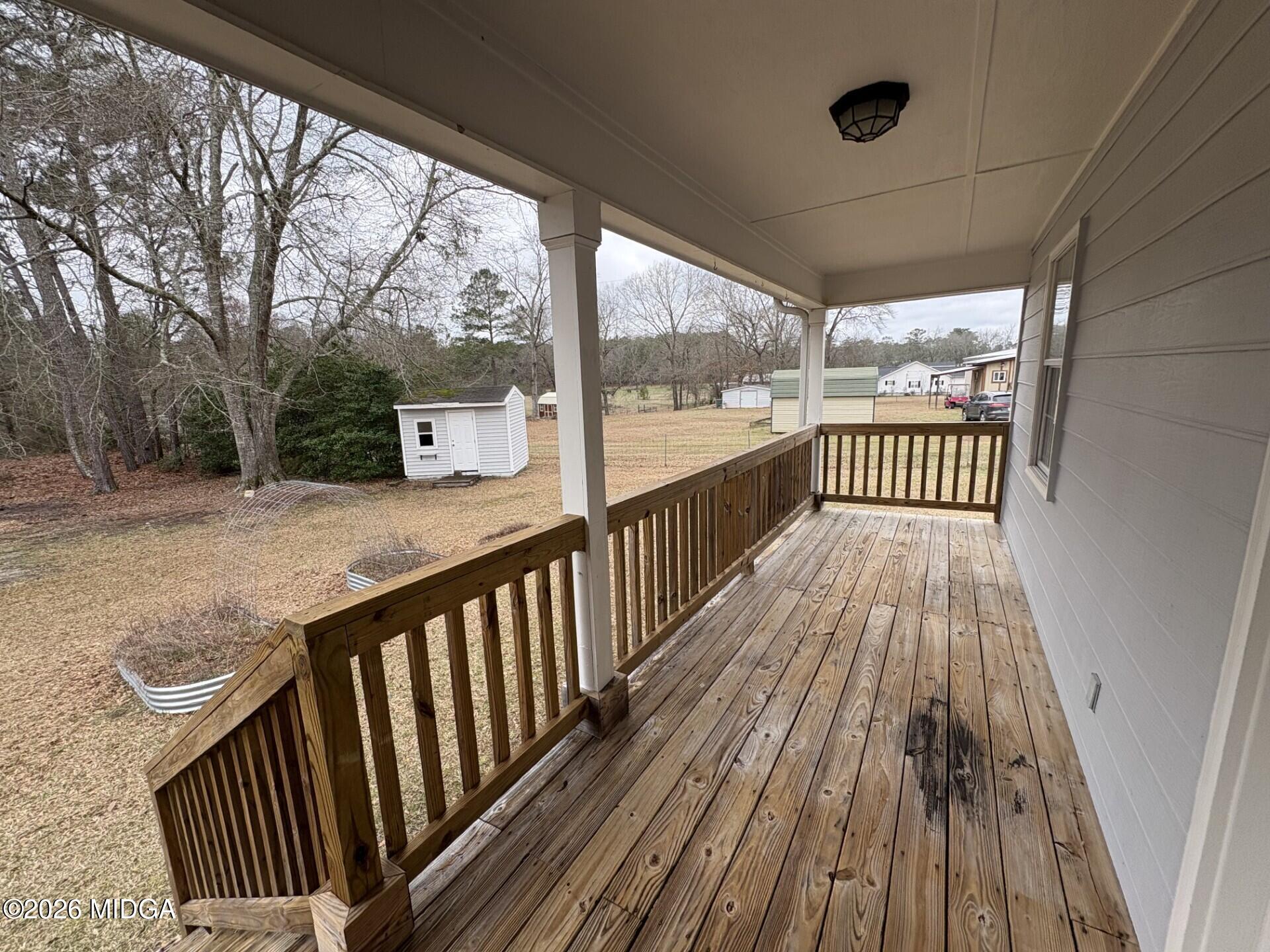 5081 Marshall Mill Road Lizella, GA 31052 - Photo 10 of 40 a view of balcony with wooden floor and fence