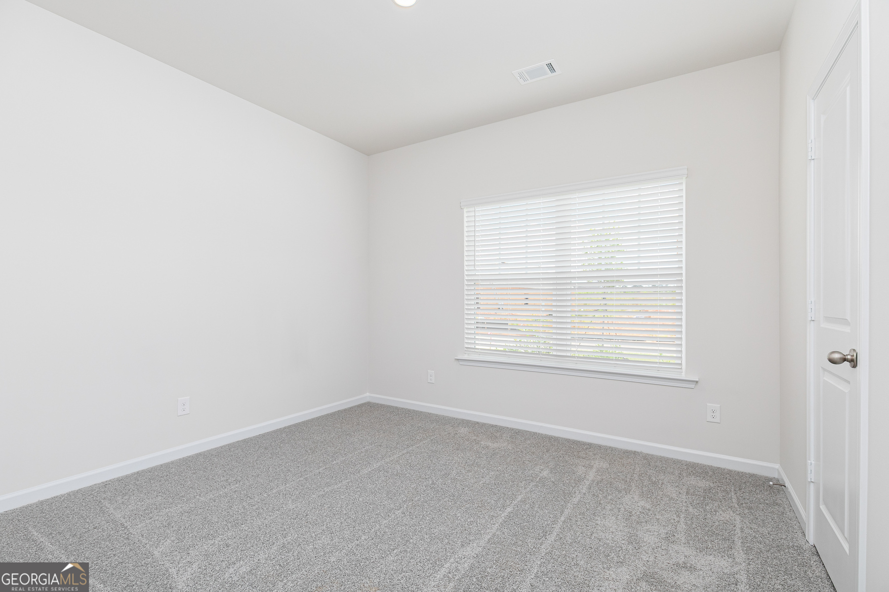 516 Plant Road Conyers, GA 30013 - Photo 9 of 11 an empty room with a window