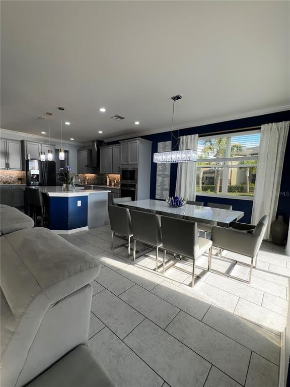 12351 Northover Loop Orlando, FL 32824 - Photo 20 of 58 a living room with stainless steel appliances kitchen island granite countertop a sink and cabinets