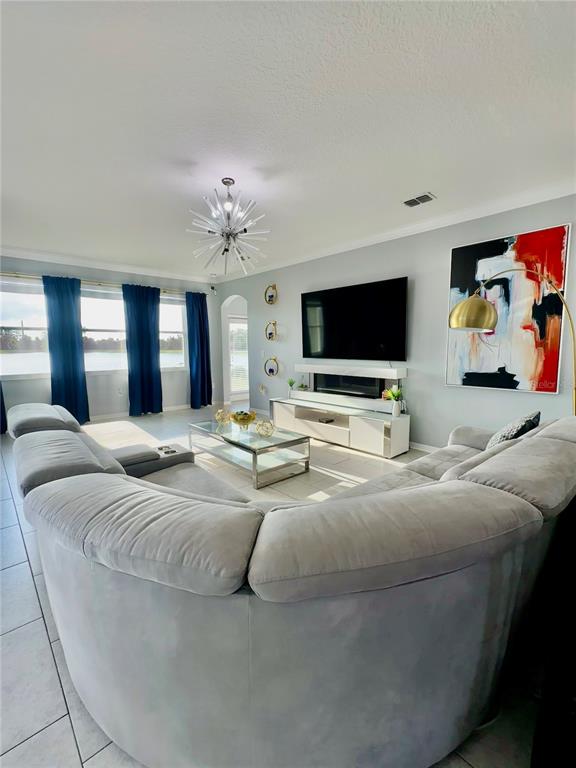 12351 Northover Loop Orlando, FL 32824 - Photo 21 of 58 a spacious bedroom with a bed and a flat screen tv