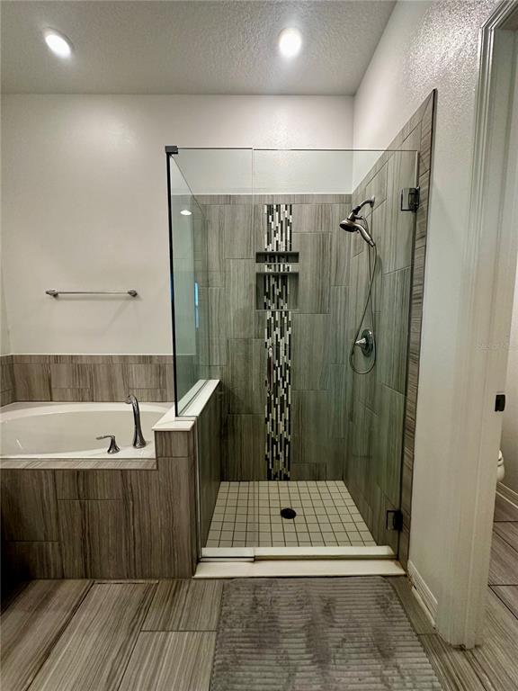 12351 Northover Loop Orlando, FL 32824 - Photo 30 of 58 a bathroom with a sink a shower and a bathtub