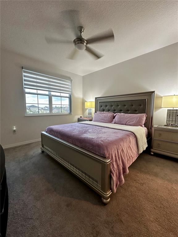 12351 Northover Loop Orlando, FL 32824 - Photo 46 of 58 a bed sitting in a room next to a lamp